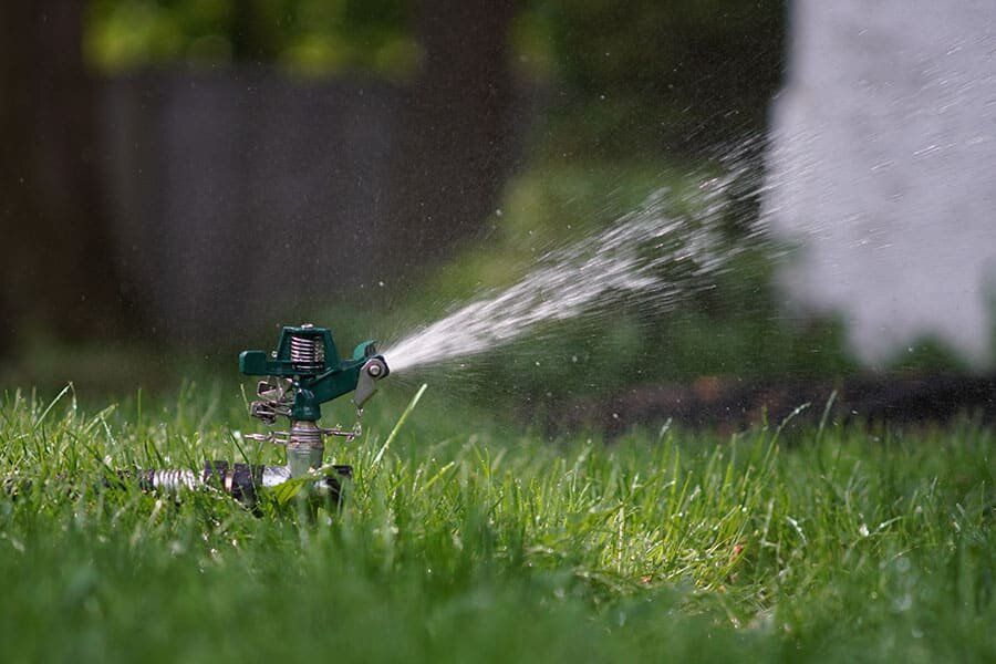 sprinkler watering healthy grass to represent lawn care services in Mendota Heights, MN.